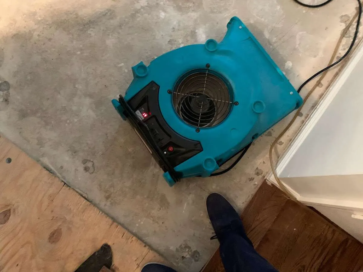 Air mover drying subfloor during Commercial Water Damage Restoration in Highlands Ranch